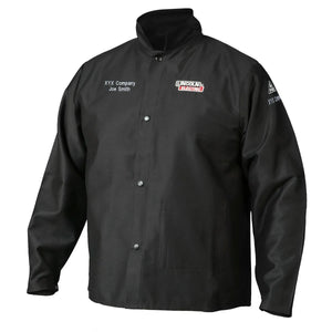 The Lincoln K2985-L Traditional FR Cloth Welding Jacket in black features snap buttons, a standing collar, embroidered XYX Company Joe Smith above a Lincoln Electric logo on the left chest, and XYX Company branding on the right sleeve.