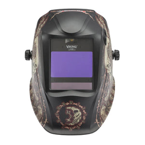 The Lincoln VIKING 2450 ADV Series Graveyard Shift Welding Helmet (K3099-5) features a black shell, large 4C Lens Technology auto-darkening visor, side knobs, and red/tan skulls, numbers, plus the VIKING logo above the purple lens.