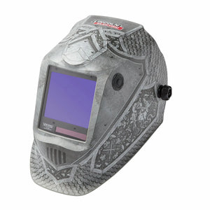 The Lincoln VIKING 3350 Medieval Welding Helmet (K4671-4) features a knight armor design with scales, shields, and a lion crest, a large auto-darkening lens, side adjustment knobs, and gray-silver coloring.