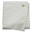 A folded Lincoln Welding Curtain (6 ft x 6 ft, K3252-1) with two brass grommets in one corner, visible edge stitching, a textured white surface, and one corner turned up to show both sides of this FM 4950 certified, 550°C rated material.