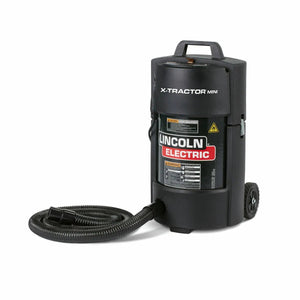 The Lincoln X-Tractor Mini (120/1/60) K3972-3 is a black, wheeled portable welding fume extractor with a carrying handle, flexible base hose, and safety labels—designed for industrial fume extraction.