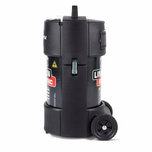 A black, cylindrical Lincoln X-Tractor Mini (120/1/60) K3972-3 high vacuum fume extractor stands upright on two wheels with a top handle, side latch and warning label, product branding, and an electric warning symbol against a plain white background.