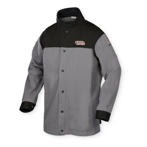 The Lincoln K4931-L XVI Series Industrial FR Welding Jacket (Large) features snap buttons, a stand-up collar, black cuffs, a black upper chest/shoulders, gray body, and Lincoln Electric logo patches on the left chest and arm.