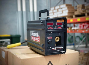 Lincoln Activ8X Wire Feeder Machine U3519-1 with CrossLinc Technology—black welding tool demo on display box at WeldingMart.